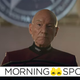 Jean-Luc Picard stands in front of a partial Starfleet logo, wearing a formal admiral's uniform.
